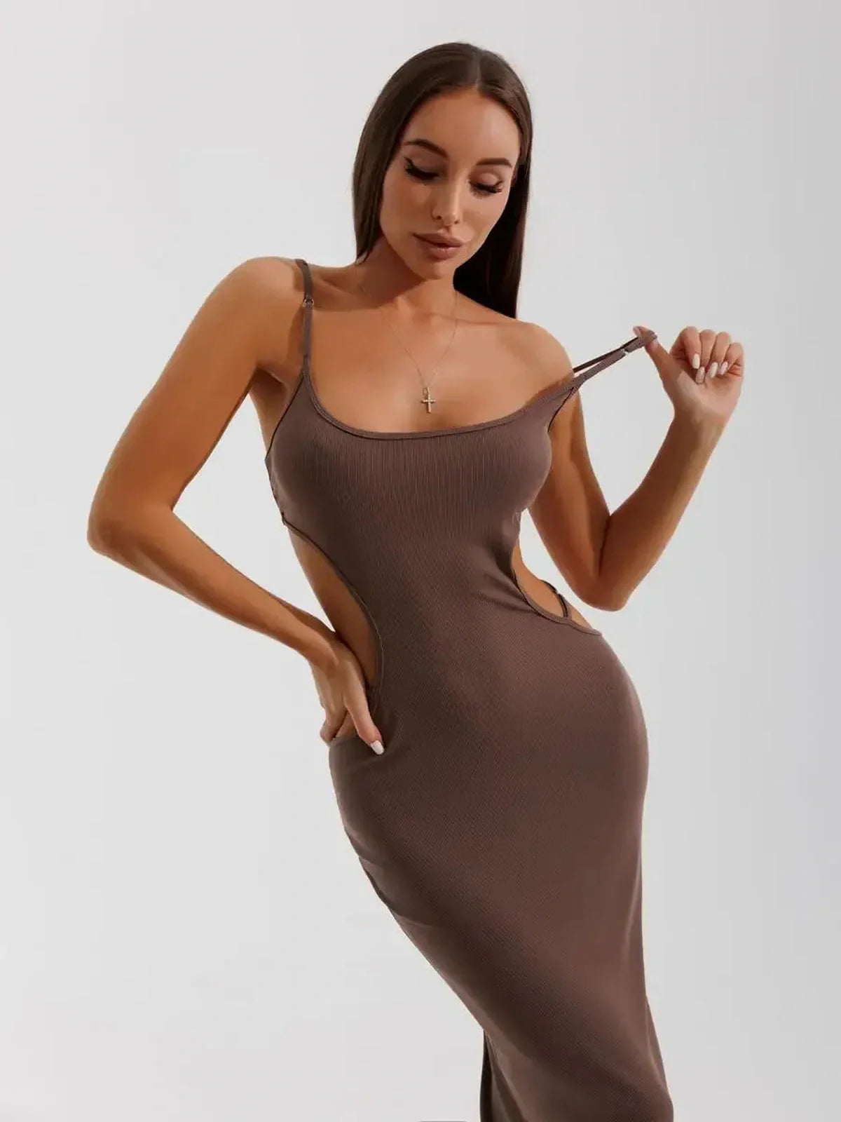 Woman wearing Obsidian Curve Midi Dress with side cut-outs, showcasing its bodycon silhouette and stylish design.