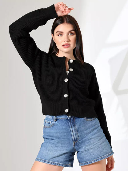Woman wearing a Nova Cardigan by Lauven, featuring a sleek black design and button-front closure paired with denim shorts.