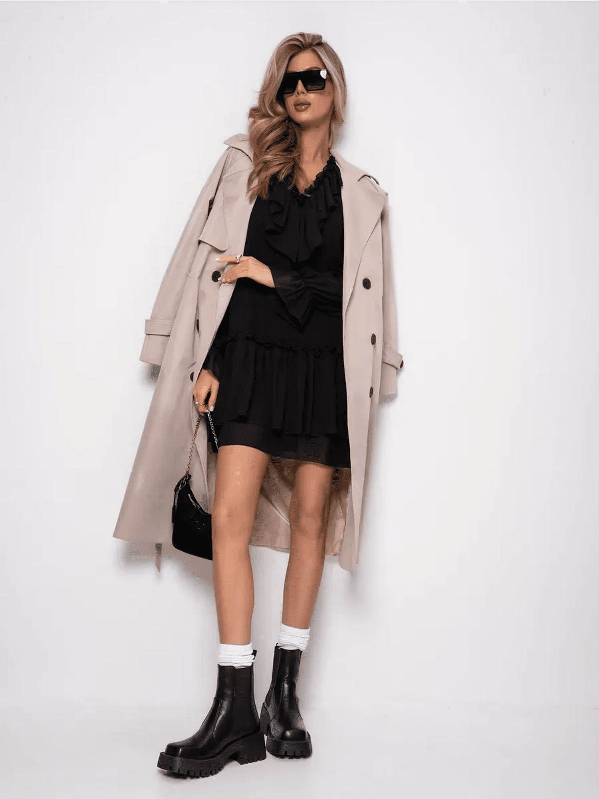 Model wearing Lauven Noirelle Mini Dress with a trench coat, stylish boots, and sunglasses.