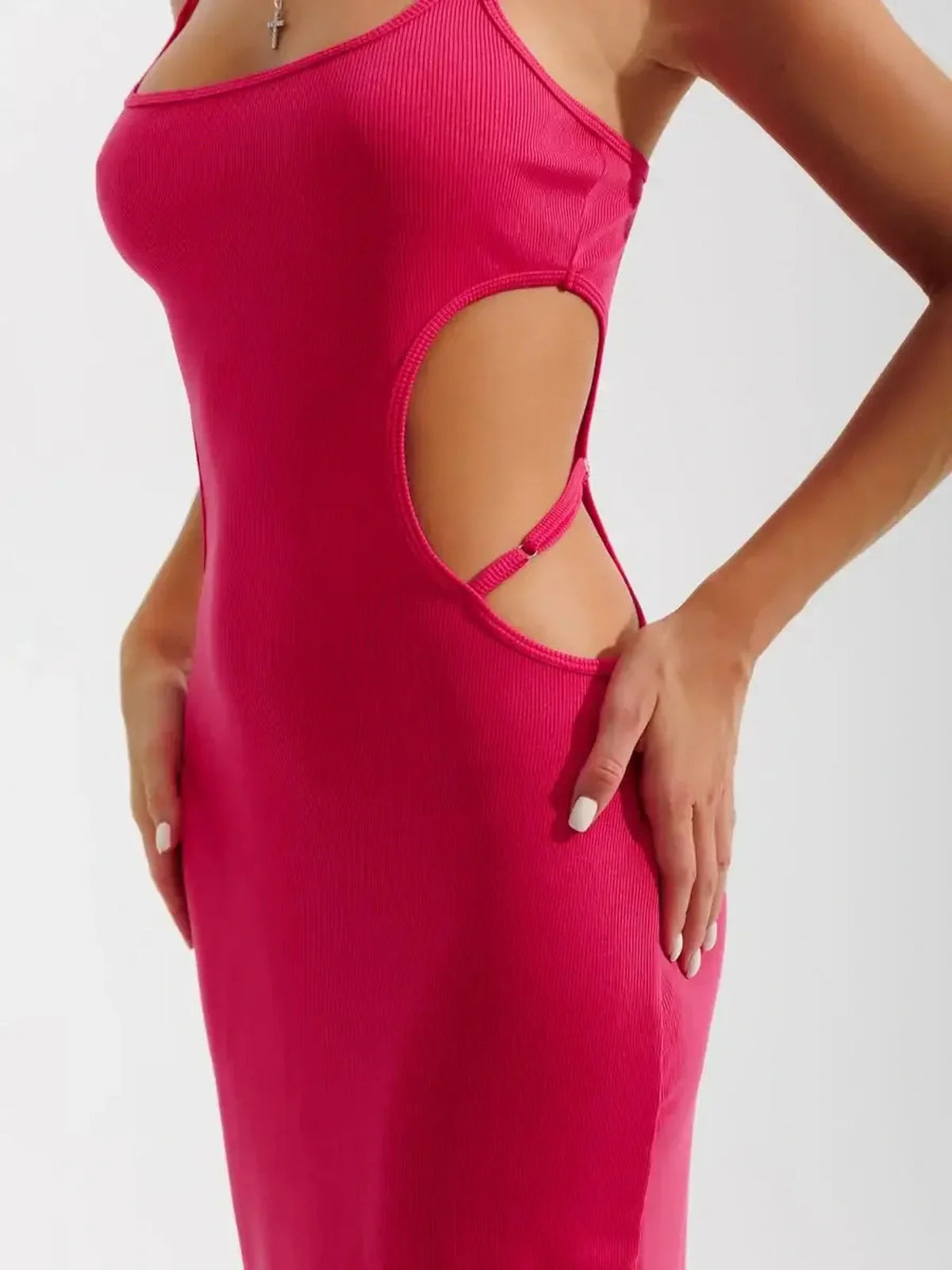Close-up of a model wearing a pink Sculpt Midi Dress showcasing side cutouts and ribbed fabric.