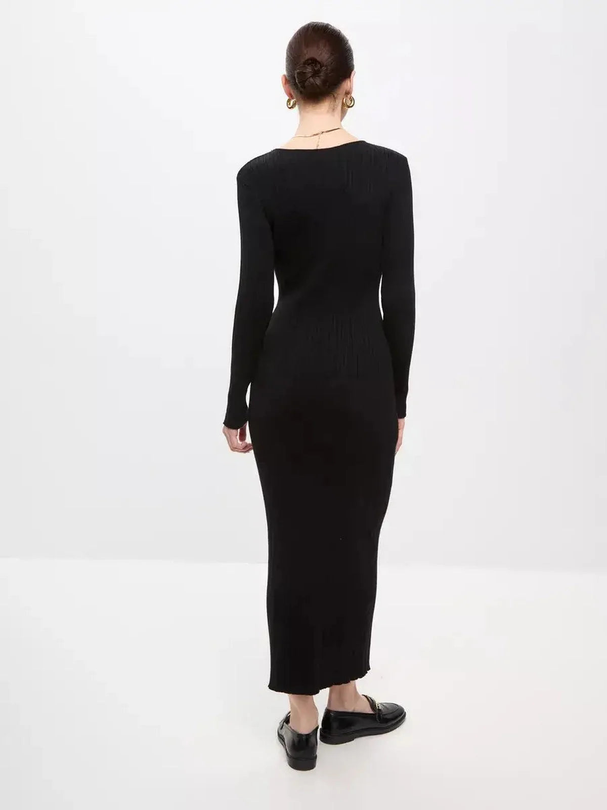 Back view of the Sculpted Rib Maxi Dress showcasing its streamlined silhouette and ribbed texture.