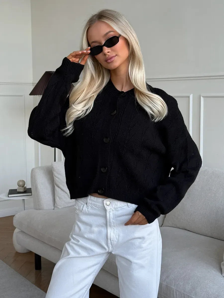 Model wearing Onyx Cardigan by Lauven, a stylish button-up knit with soft textured fabric.