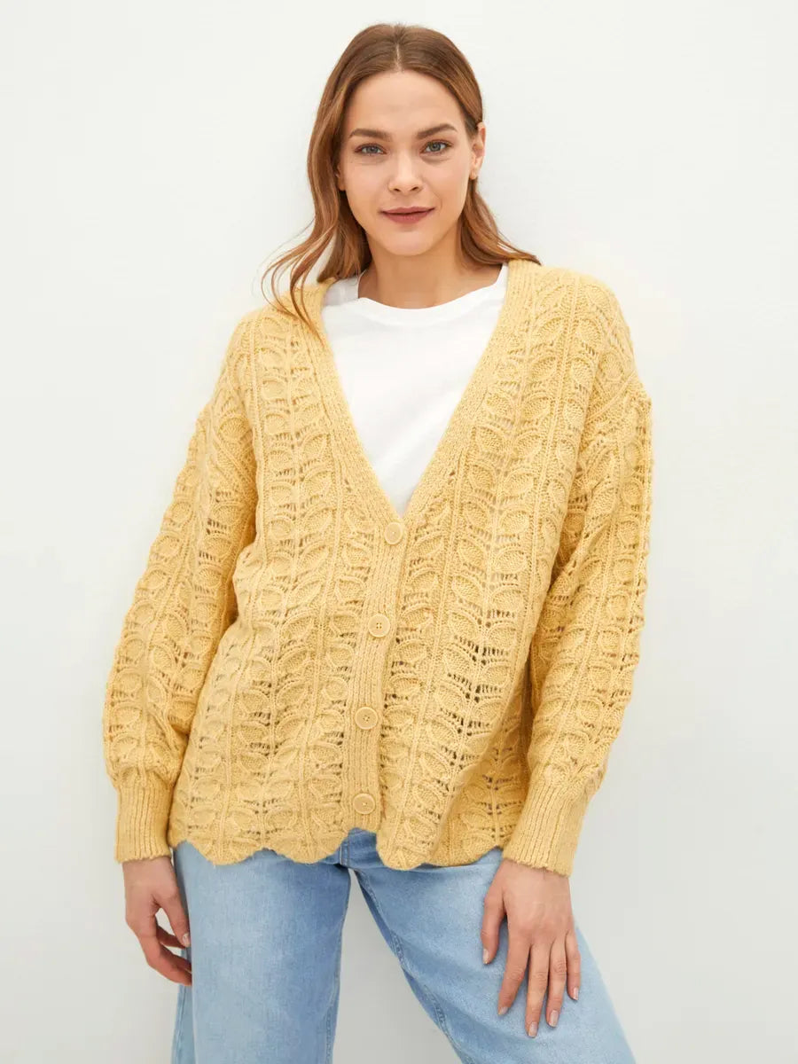 Solenne Cardigan by Lauven in warm yellow knit, featuring textured jacquard and V-neckline for relaxed elegance.