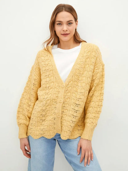 Solenne Cardigan by Lauven in warm yellow knit, featuring textured jacquard and V-neckline for relaxed elegance.
