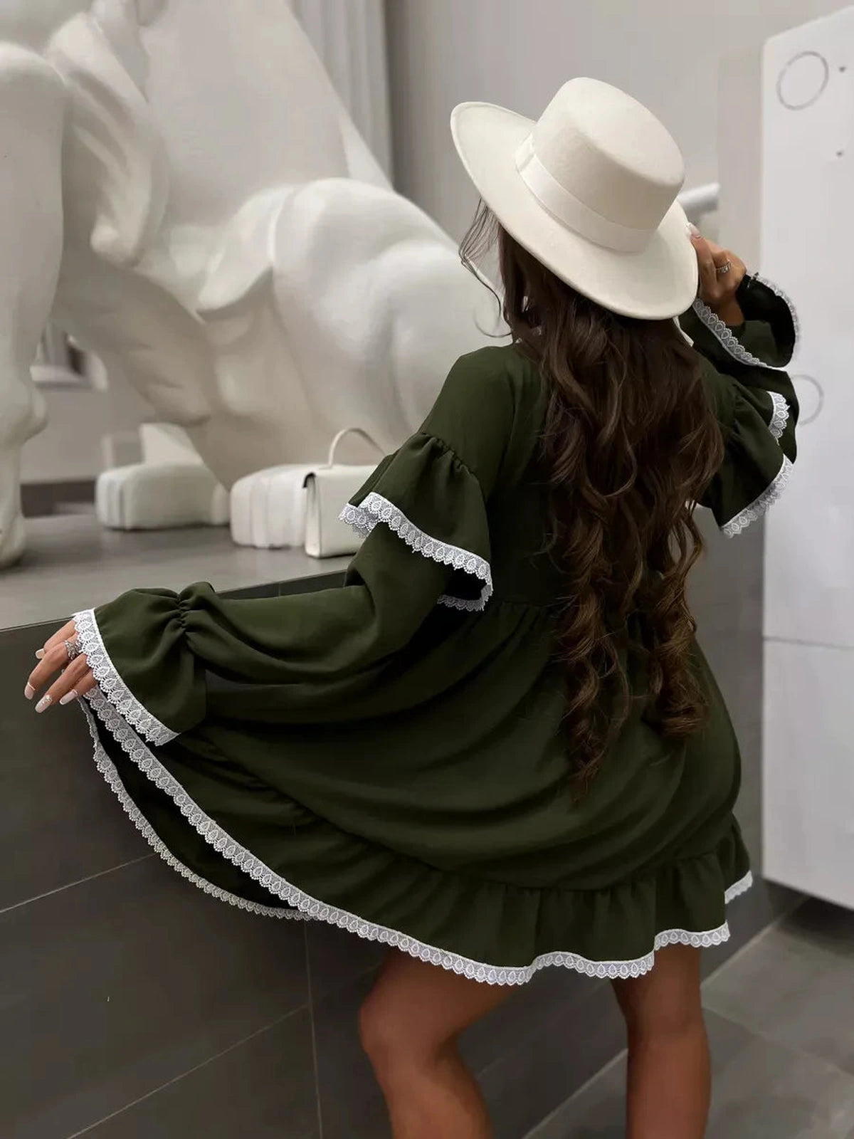 Olivea Mini Dress by Lauven featuring romantic ruffles and lace trim, styled effortlessly in khaki.