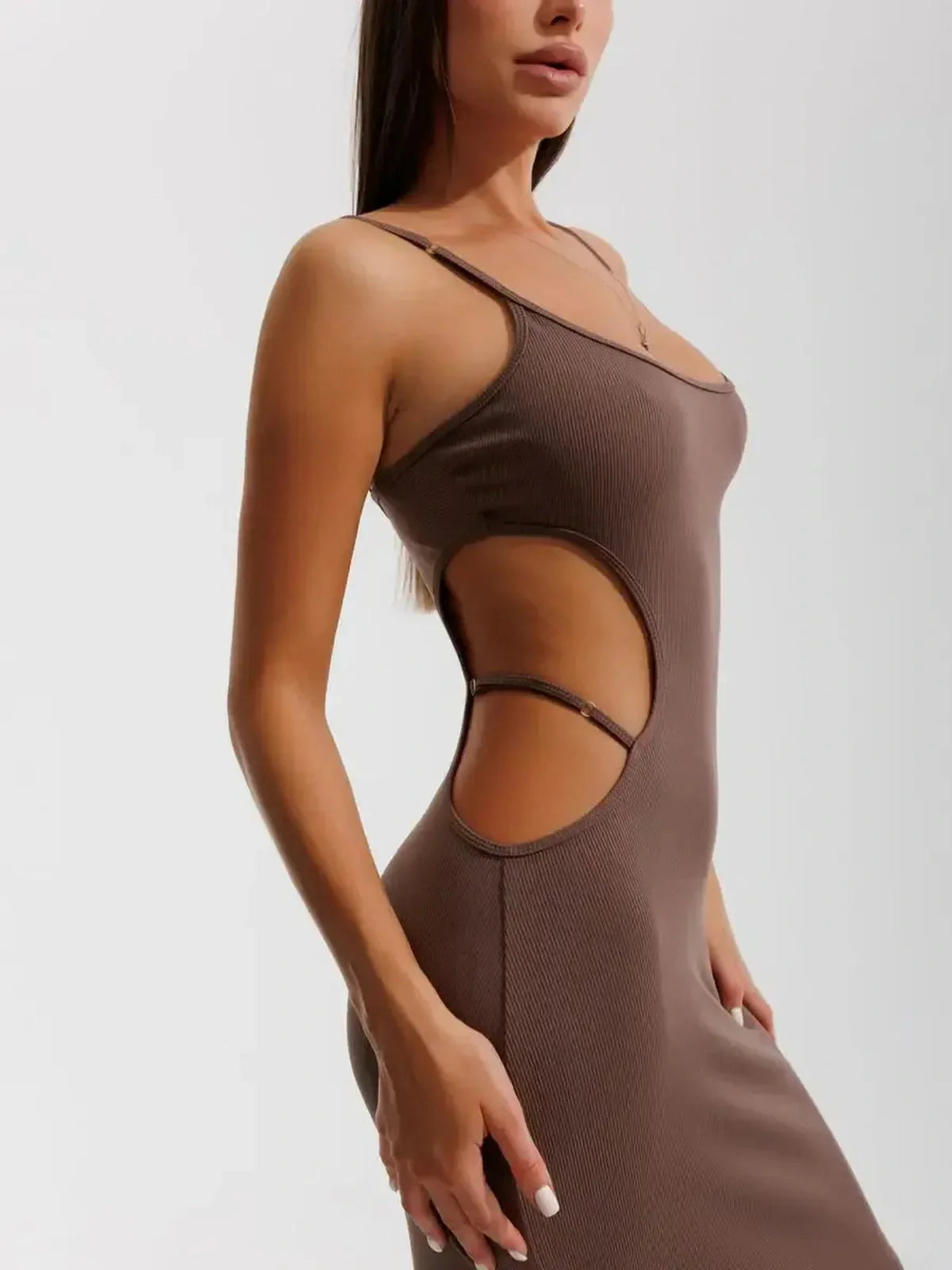 Model showcasing the Obsidian Curve Midi Dress, featuring seductive side cut-outs and form-fitting design.