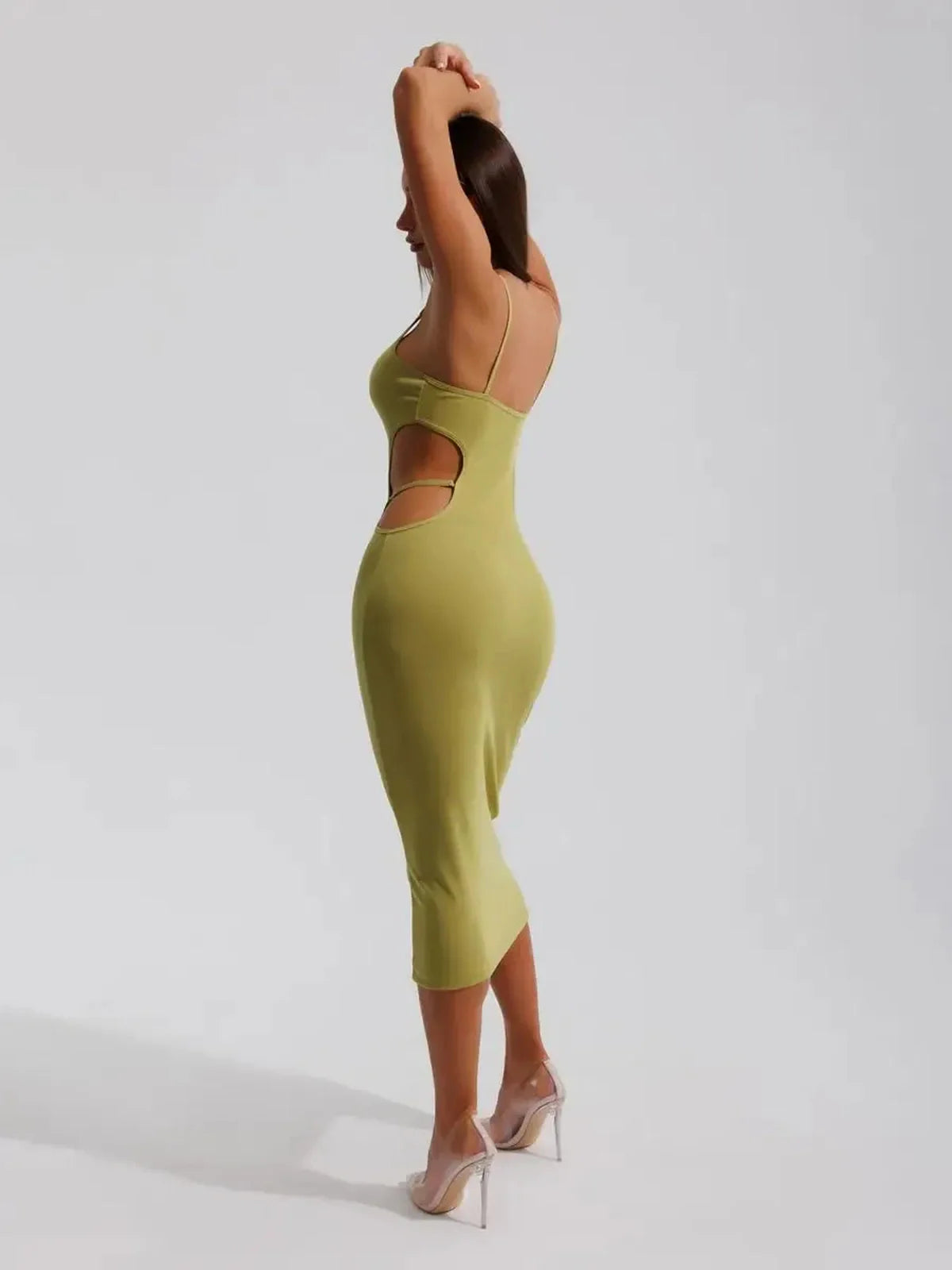 Back view of a women in a pistachio Sculpt Cutout Midi Dress with side cut-outs, showcasing a sleek silhouette.