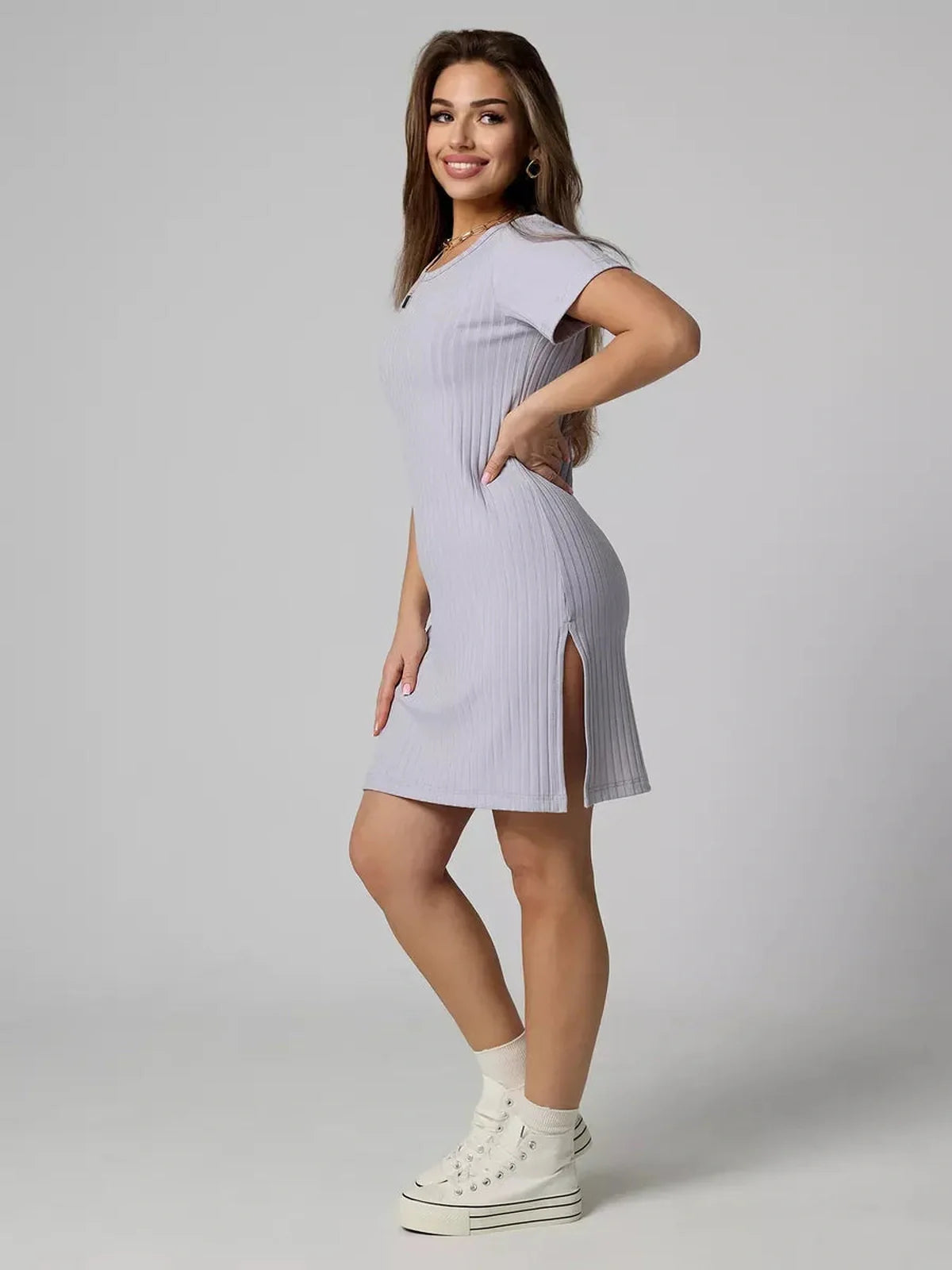 Model showcasing the Cloudline Mini ribbed summer dress in light purple, featuring a relaxed cut and short sleeves.