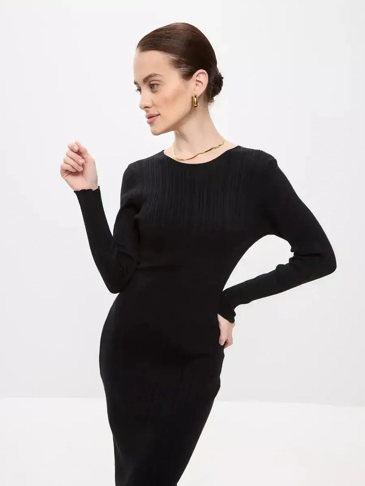 Model wearing a fitted black Sculpted Rib Maxi Dress showcasing its streamlined silhouette and ribbed texture.