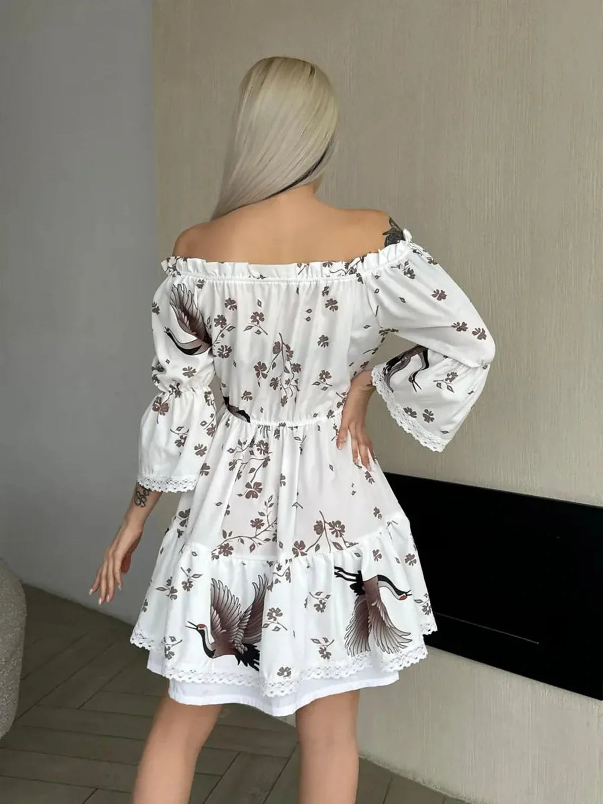 Back view of the elegant White Crane mini dress featuring crane and floral motifs in white with mocha-brown accents.