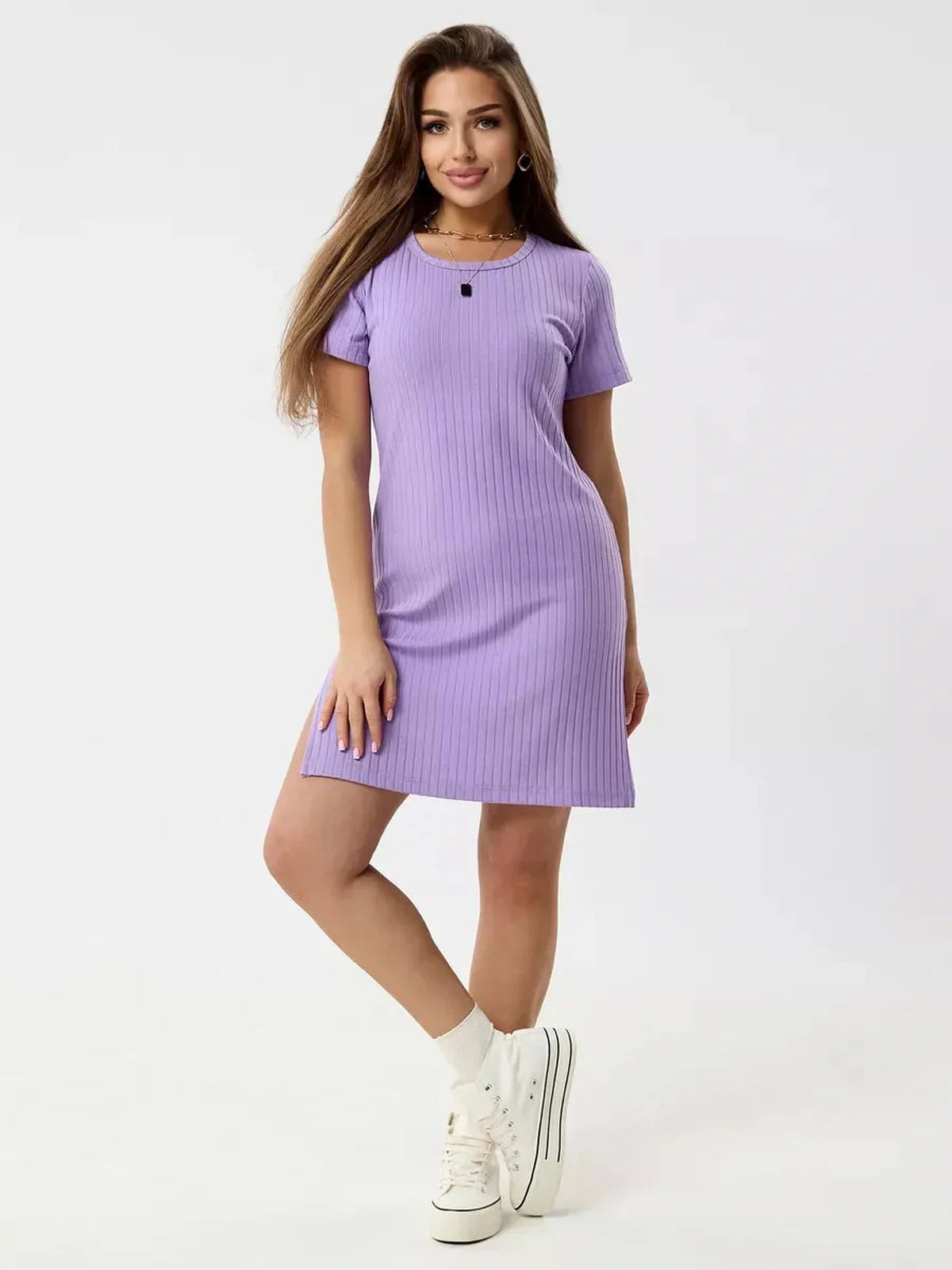 Model showcasing a lilac ripple mini dress with ribbed knit texture and short sleeves, perfect for warm days and lively nights.