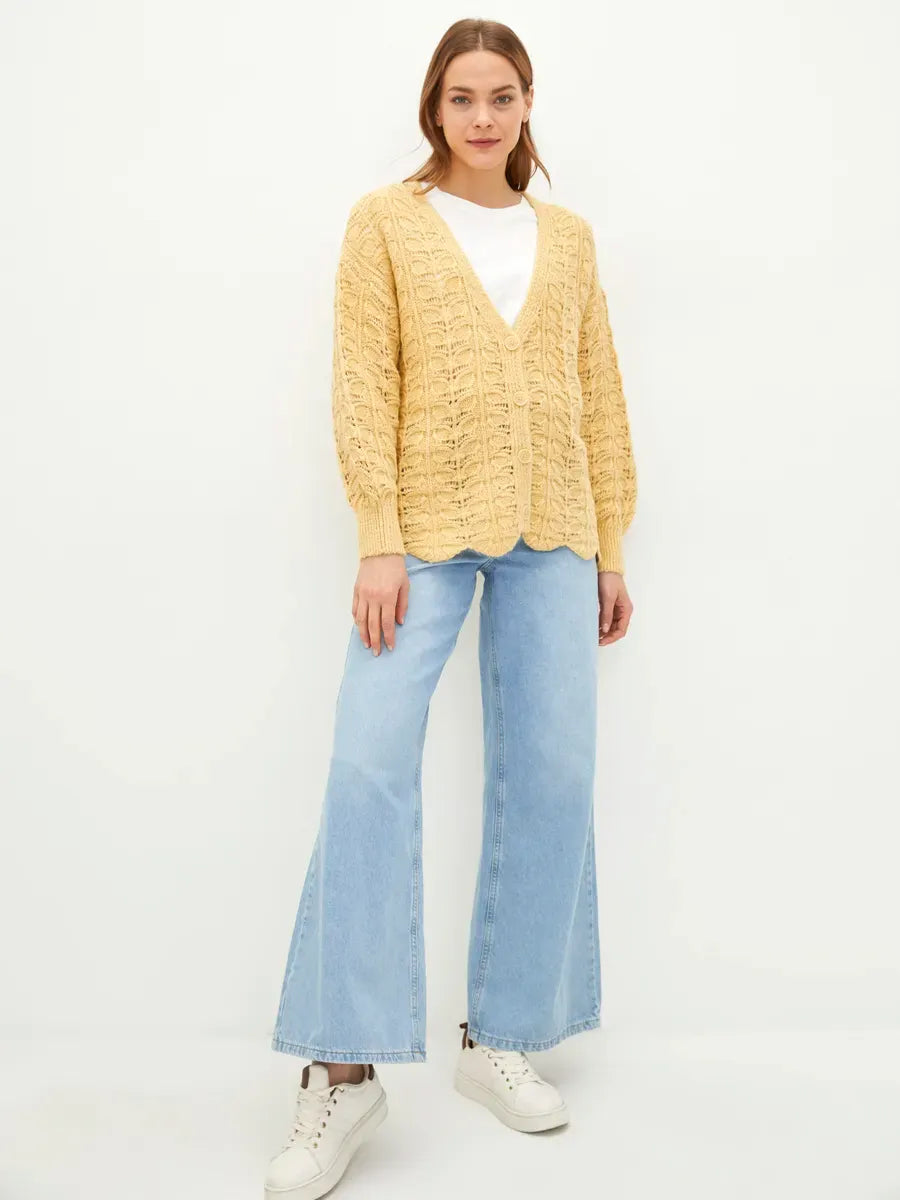 Solenne Cardigan by Lauven, a textured knit cardigan in warm yellow, styled with relaxed elegance and casual jeans.