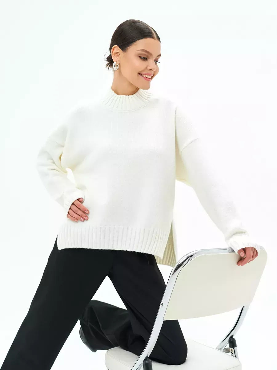Astra Sweater by Lauven, oversized wool blend knit in cream white, styled with black pants.