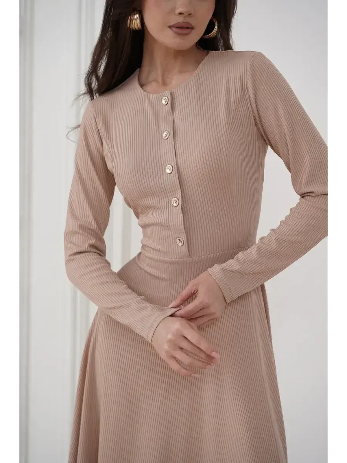 Sculpted Ease Midi Dress in ribbed knit with button accents, showcasing a fitted waist and elegant beige hue.