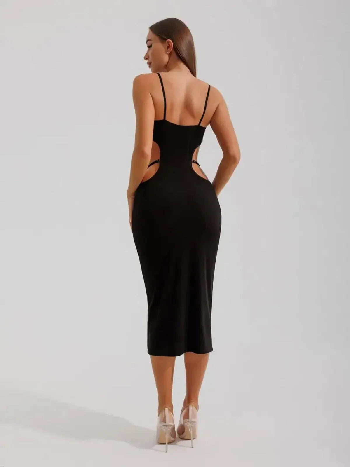 Model showcasing the back of the Midnight Silhouette Midi Dress with curve-hugging cutouts and sculpted fit.