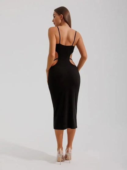 Model showcasing the back of the Midnight Silhouette Midi Dress with curve-hugging cutouts and sculpted fit.