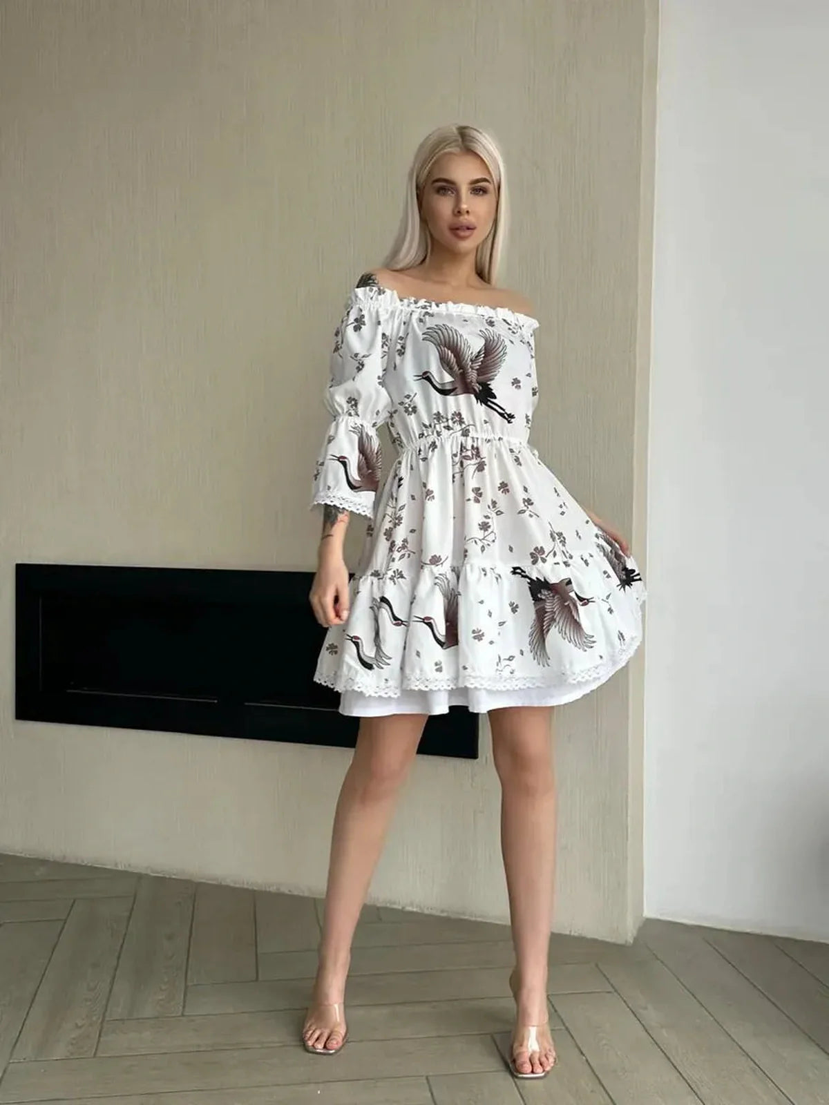 Elegant woman in a White Crane summer dress with floral and crane motifs, showcasing romance and modern artistry.