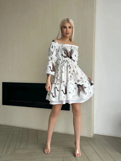 Elegant woman in a White Crane summer dress with floral and crane motifs, showcasing romance and modern artistry.