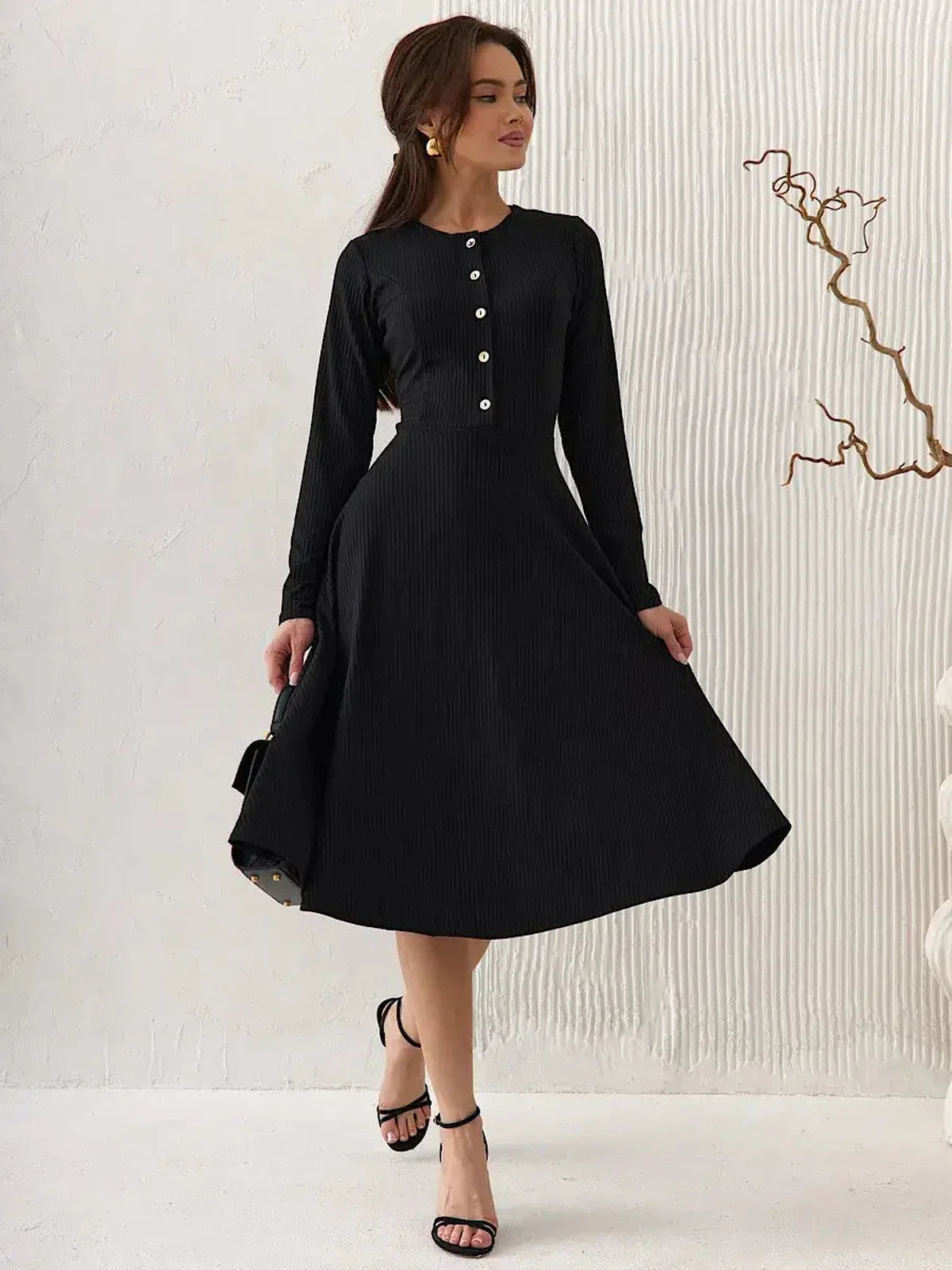 Serene Grace Midi Dress in black ribbed fabric, featuring long sleeves and decorative buttons, perfect for elegant occasions.