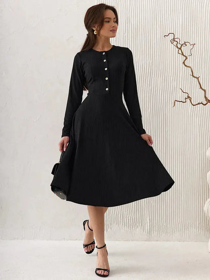 Serene Grace Midi Dress in black ribbed fabric, featuring long sleeves and decorative buttons, perfect for elegant occasions.