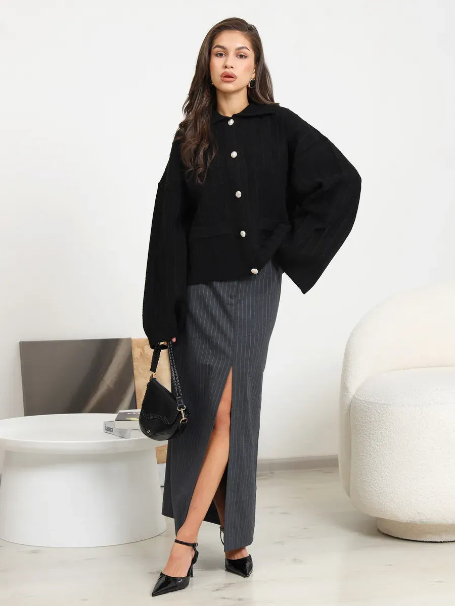 Onyx Cardigan by Lauven - Black oversized knitwear with braided pattern worn with stylish skirt.