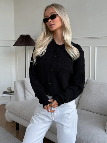 Onyx Cardigan by Lauven, featuring a stylish button-up design and soft textured fabric, worn with chic sunglasses.