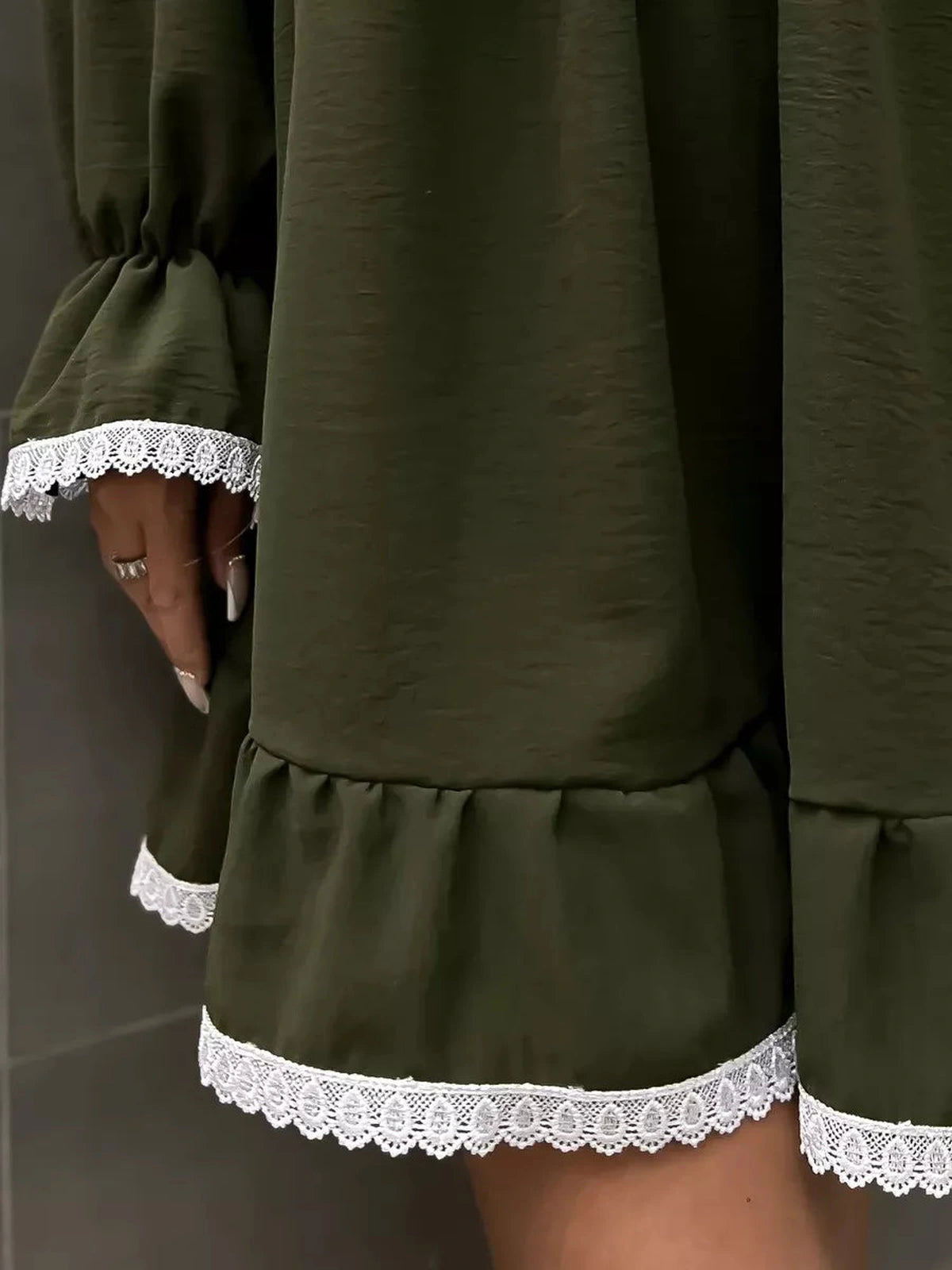 Close-up of Olivea Mini Dress by Lauven, showcasing romantic ruffles and lace trim in khaki.