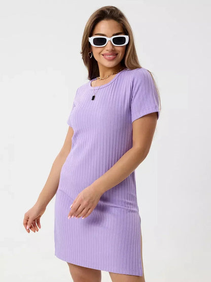 Confident model in a lilac mini dress with ribbed texture, showcasing a flattering fit and stylish round neckline.