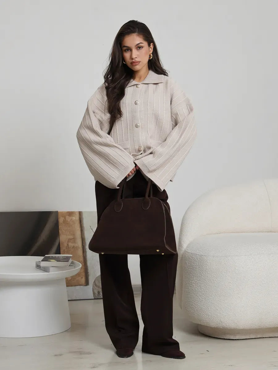 Dune Cardigan in soft light beige with oversized fit, styled with a chic brown handbag.