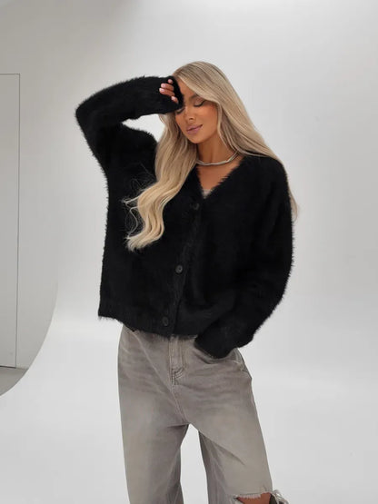 Nyx Cardigan by Lauven — Oversized black fluffy knit cardigan with button closure on model.