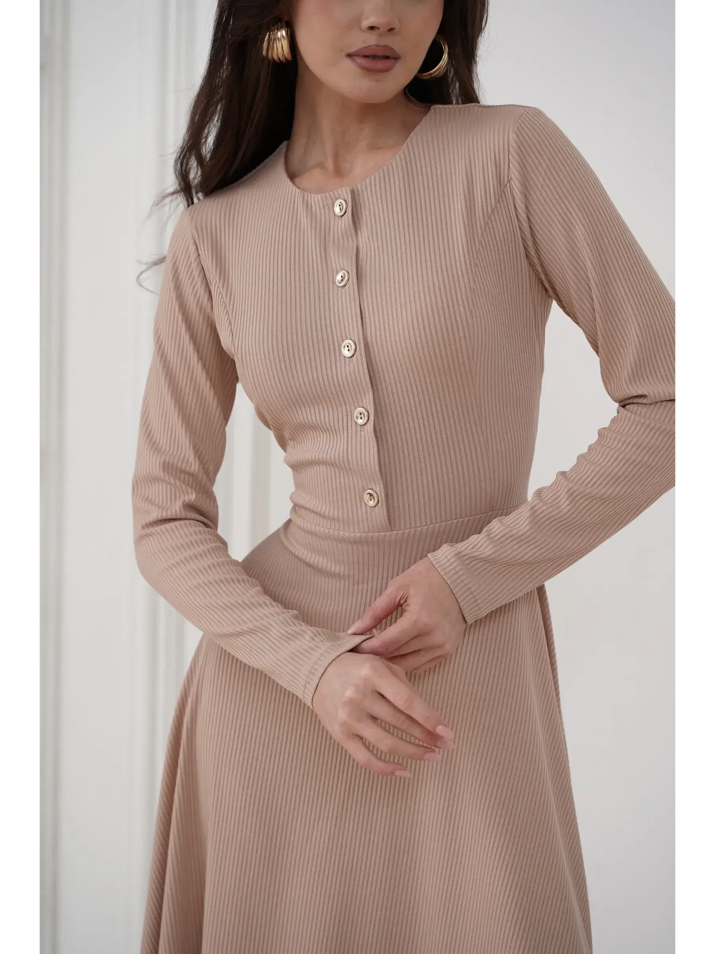 Close-up of the Sculpted Ease Midi Dress in beige, featuring ribbed knit fabric and gold-tone buttons for elegant style.