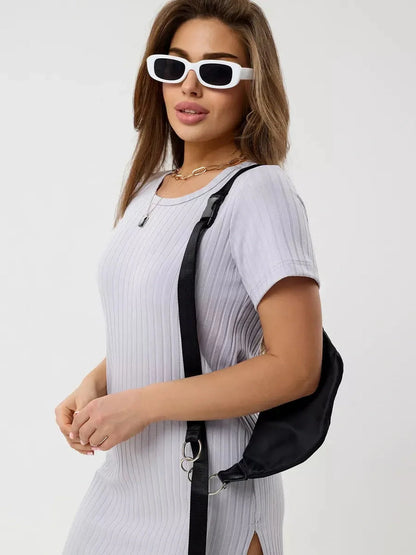 Woman in Cloudline Mini dress with short sleeves and ribbed texture, wearing stylish white sunglasses and black sling bag.
