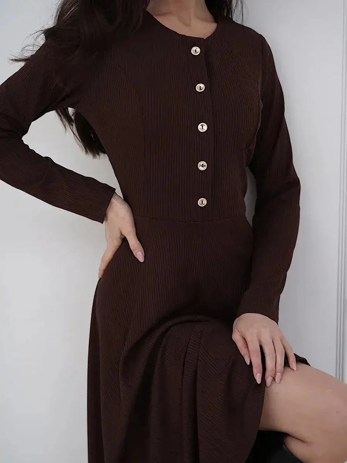 Elegant brown midi dress featuring button detailing and flattering fit-and-flare silhouette, perfect for any occasion.
