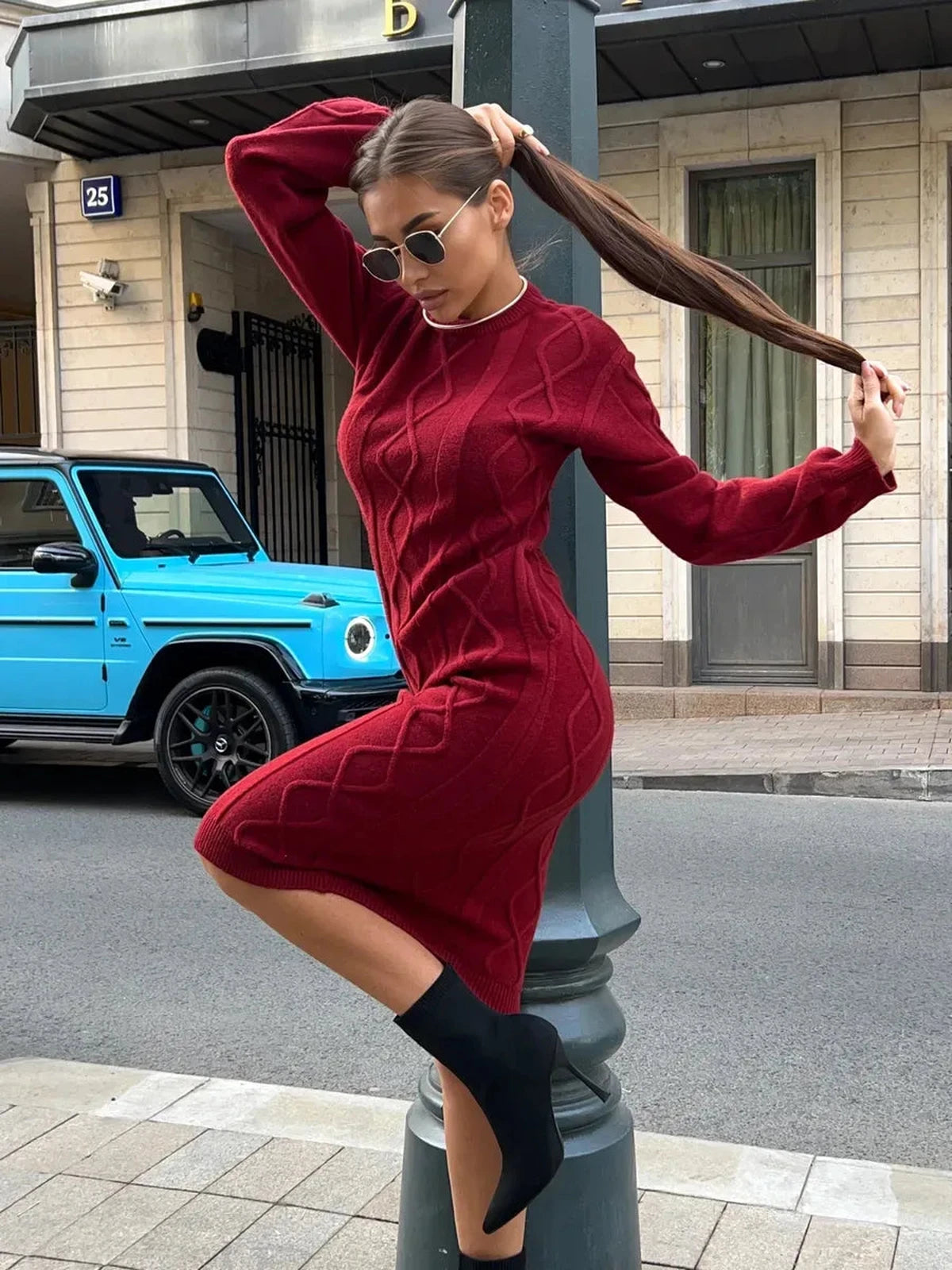 Model showcasing the Crimson Midi Dress by Lauven, a stylish textured knit dress in burgundy, perfect for cozy autumn wear.