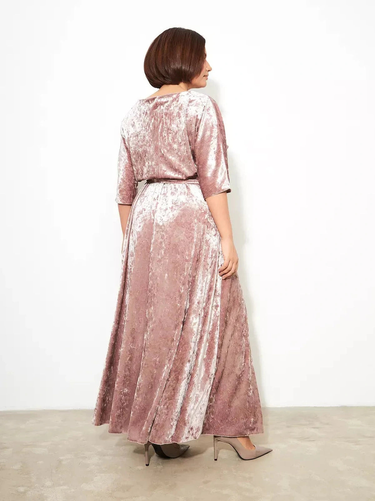 Back view of the Rosalyn Maxi Dress by Lauven, featuring soft pink crushed velvet and a flowing A-line silhouette.