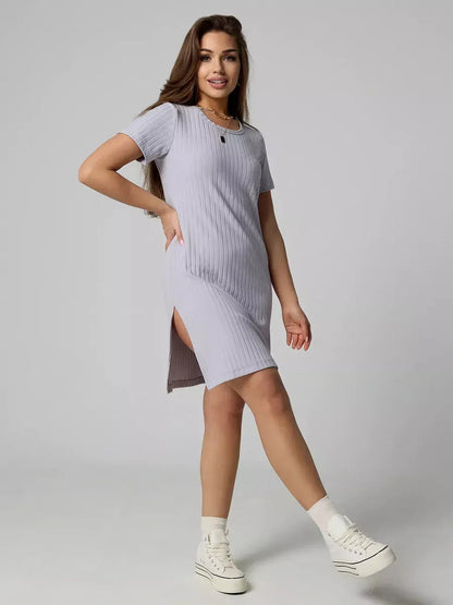 Model wearing the Cloudline Mini ribbed summer dress in light purple, showcasing short sleeves and side slit.