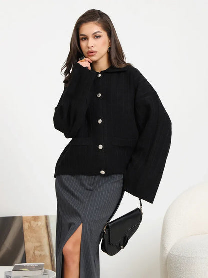 Onyx Cardigan by Lauven – Chic black oversized knitwear featuring a braided pattern and wide sleeves for sophisticated layering.