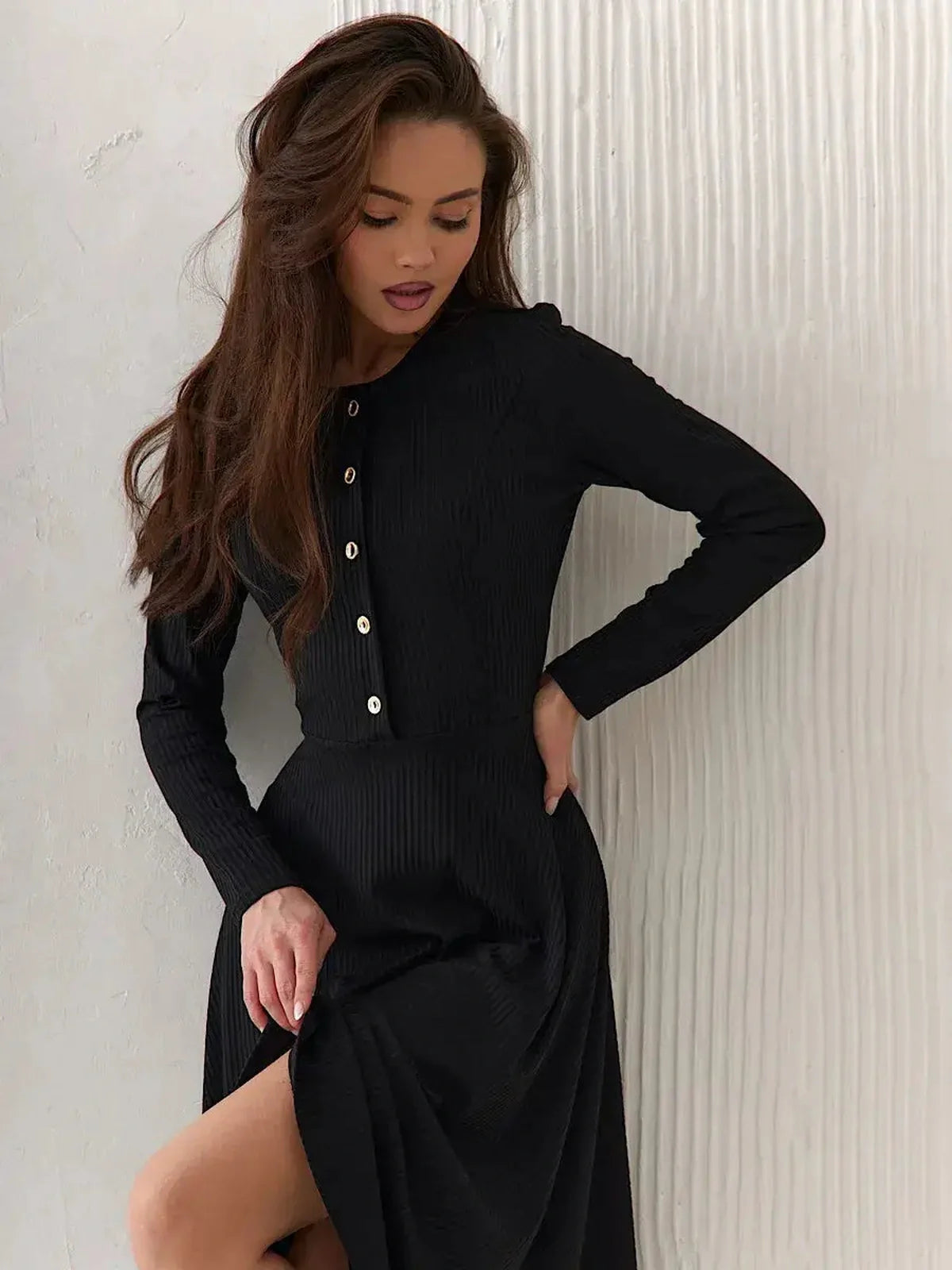 Model wearing the Serene Grace Midi Dress, showcasing its black ribbed texture and decorative buttons.