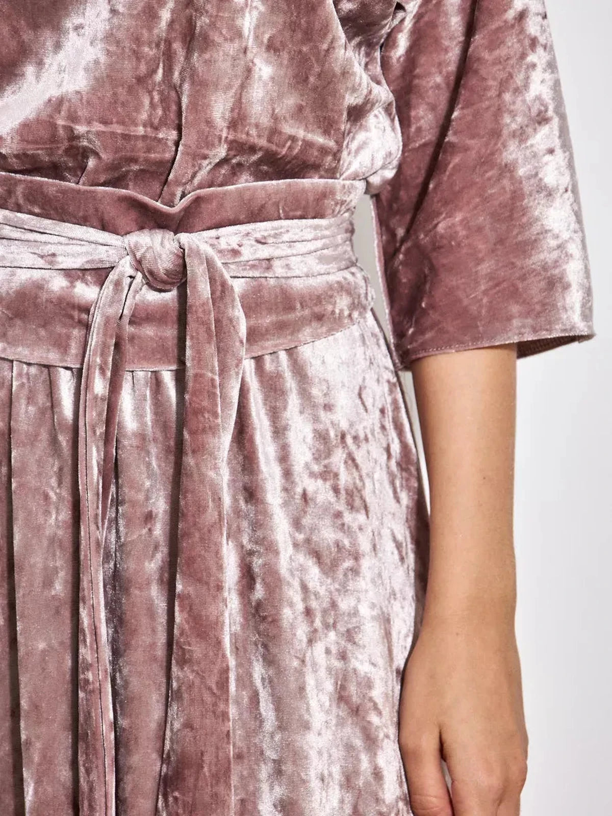 Close-up of the Rosalyn Maxi Dress in soft pink crushed velvet showcasing the adjustable belt detail by Lauven.