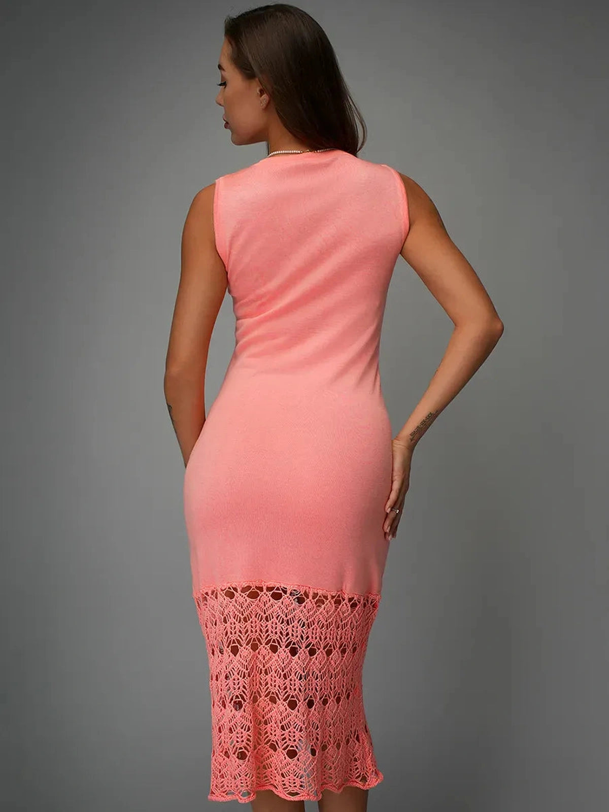 Back view of Coralia Midi Dress by Lauven in peach crochet knit, showcasing its elegant design and lace detailing.