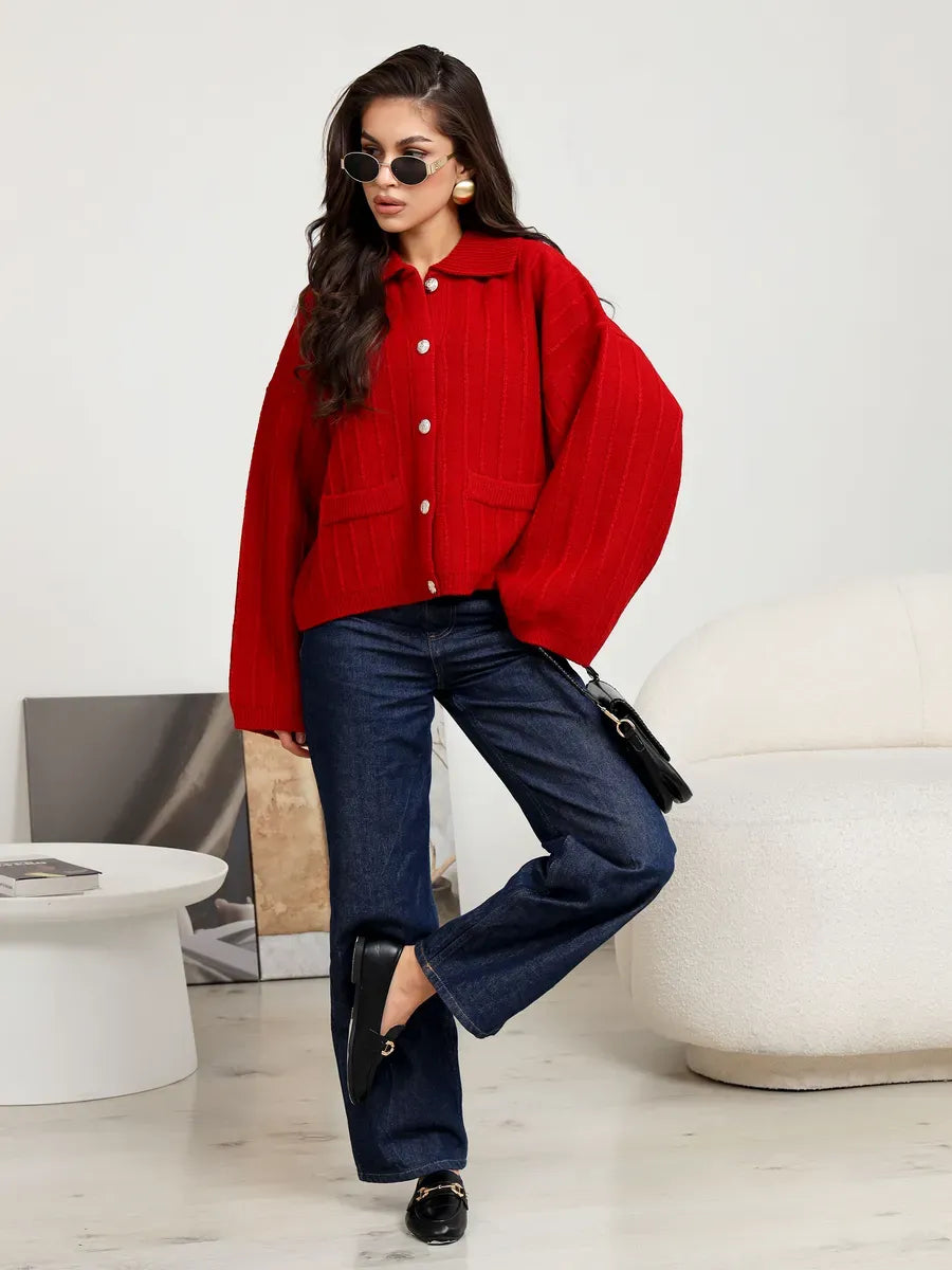 Crimson Cardigan by Lauven - Bold red oversized knitwear with braided pattern, styled with blue jeans and accessories.