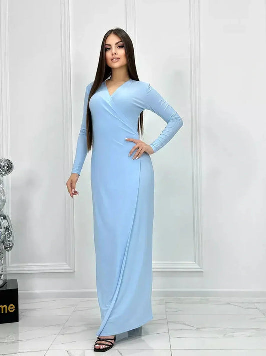 Celeste Charm Maxi Dress in light blue, featuring long sleeves and a flattering wrap silhouette for versatile styling.
