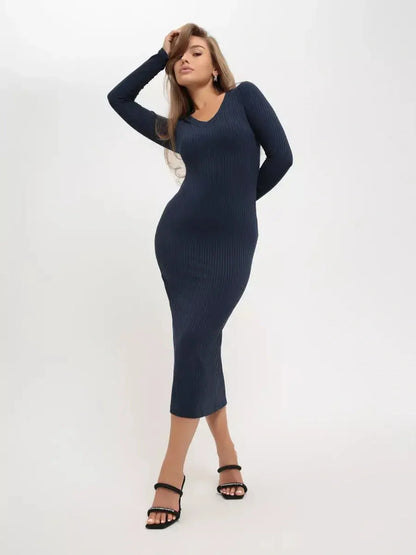 Model wearing a dark navy ribbed Contour Midi Dress with long sleeves and a V-neckline, elegantly highlighting her silhouette.