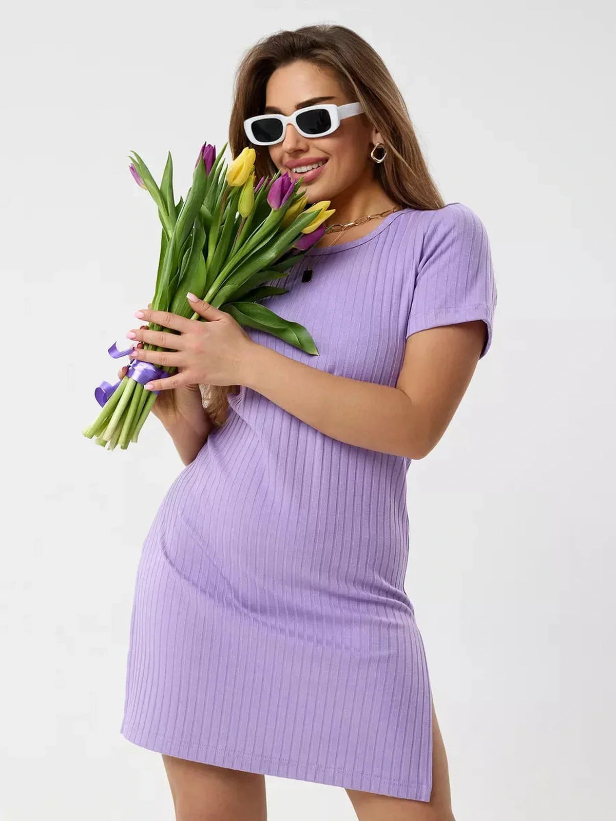Model in a lilac ribbed mini dress holding tulips, showcasing confidence and style for warm days.