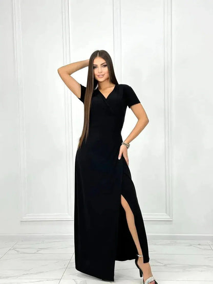 Model in an elegant black Obsidian Grace Maxi Dress with a wrap silhouette and thigh-high slit.
