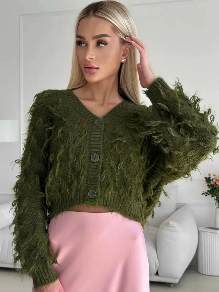 Olive Cardigan by Lauven, cropped oversized khaki bouclé knit with feathered fringe, styled with pink skirt.