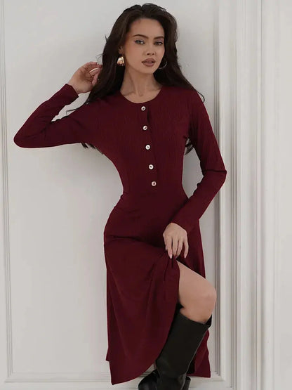 Crimson Grace Midi Dress featuring long sleeves, ribbed texture, gold buttons, and a stylish burgundy hue.