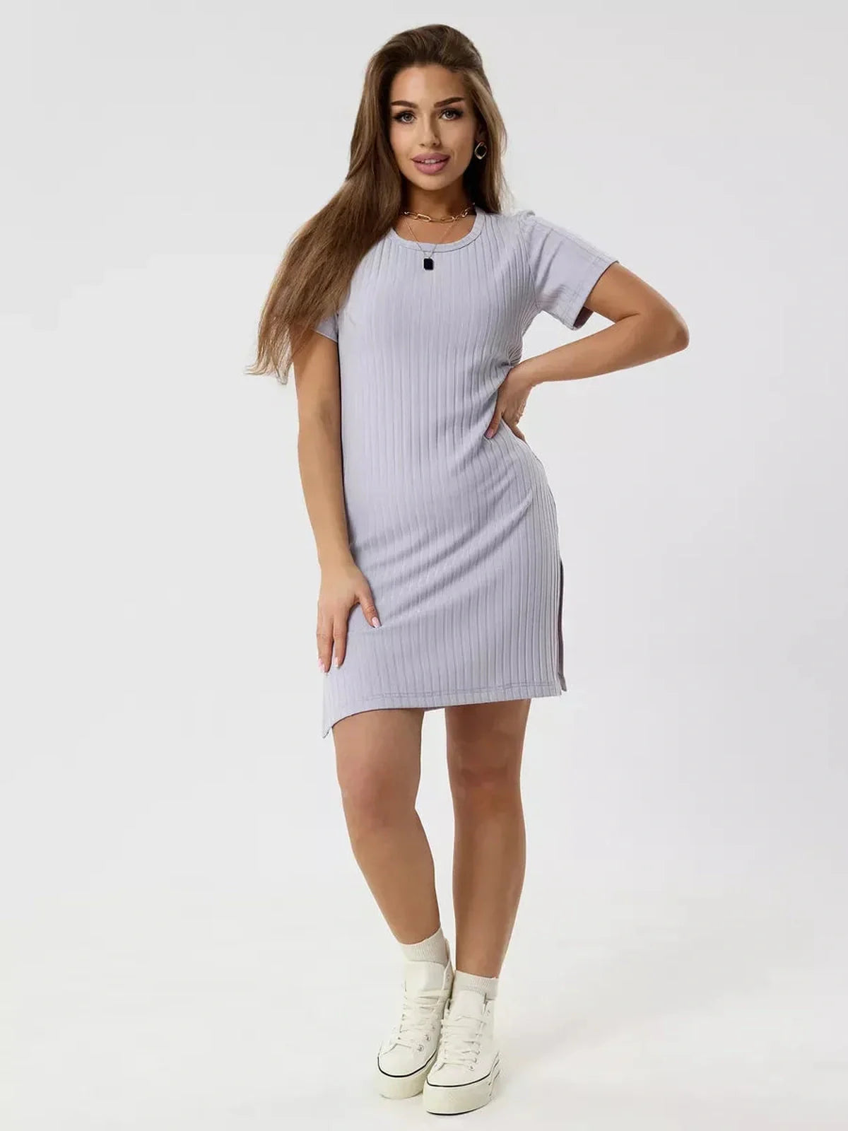 Model wearing a ribbed lavender Cloudline Mini dress, showcasing a relaxed fit and short sleeves for summer style.