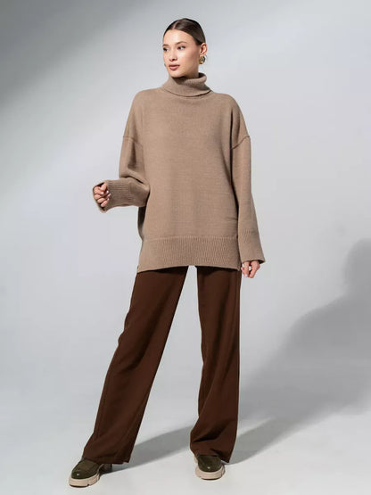 Lauven Capri Sweater in warm cappuccino shade, oversized knitwear with turtleneck, styled with brown pants.