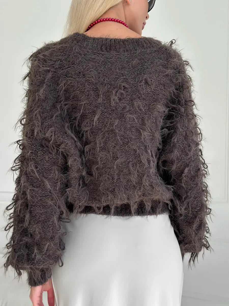 Espresso Cardigan from Lauven, showcasing a cropped, oversized brown bouclé knit with playful feathered fringe.